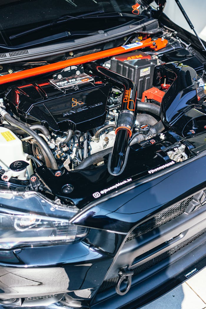 Detailed view of a modified Mitsubishi Lancer engine bay showcasing performance enhancements.